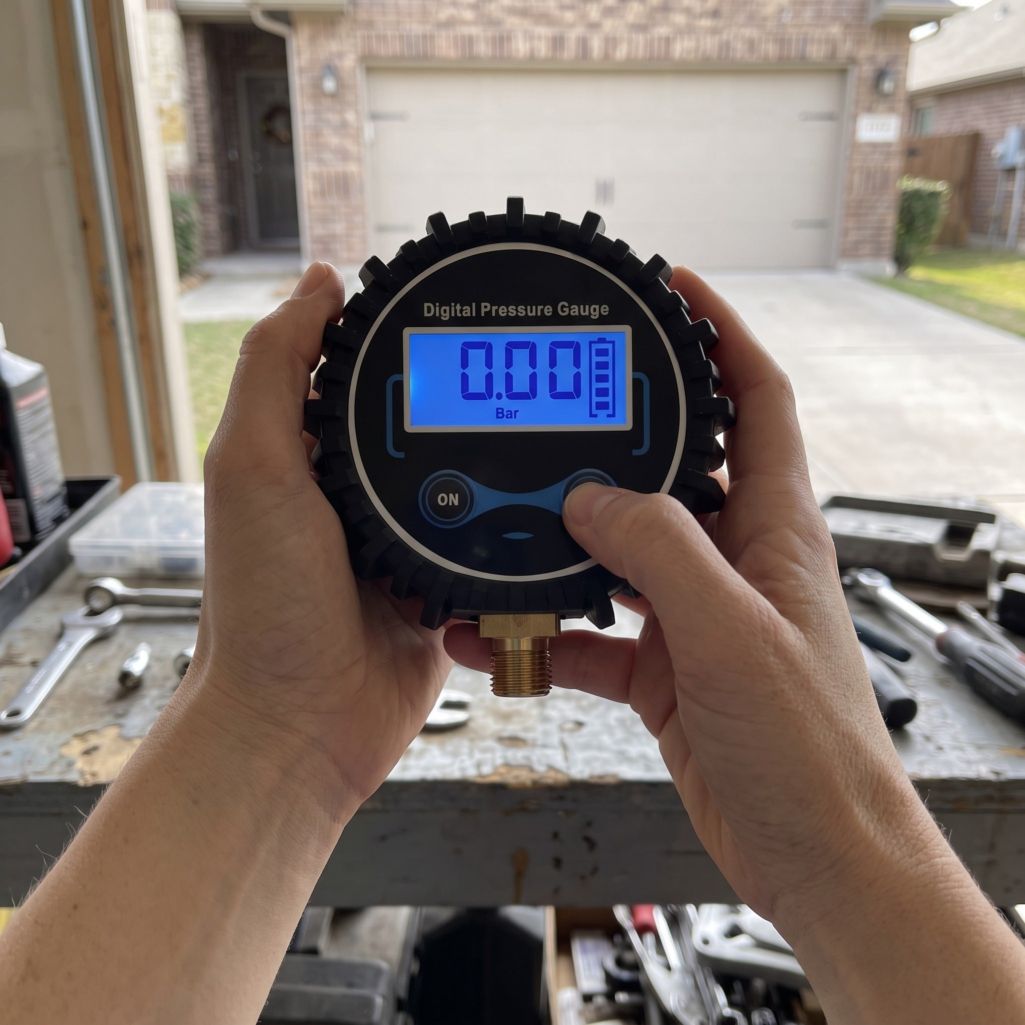 Claire M. with a Roadwell gauge in an automotive workspace